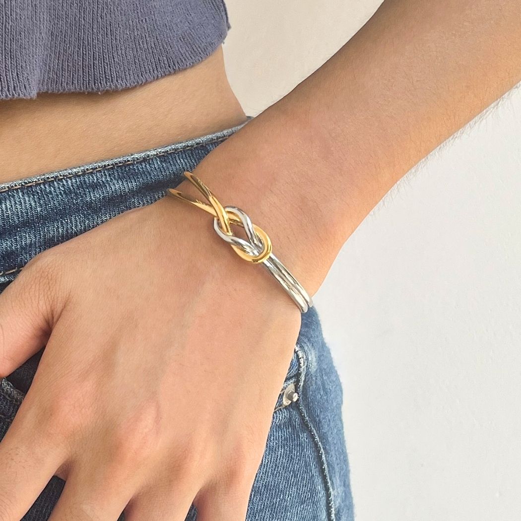Close-up of the Entwined Knot cuff bracelet on a wrist